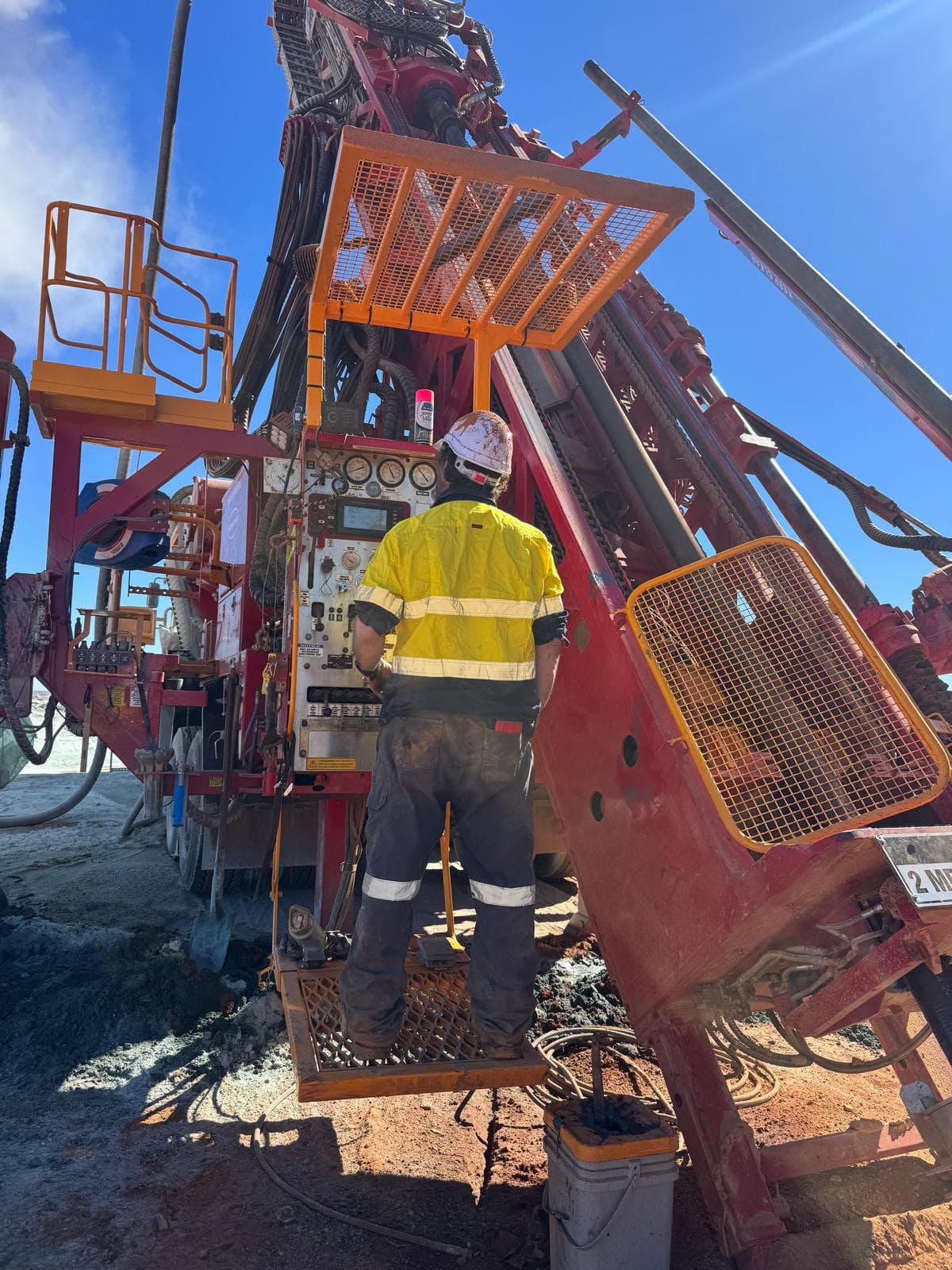 Driller operating the control panel of an Xplore Drilling rig