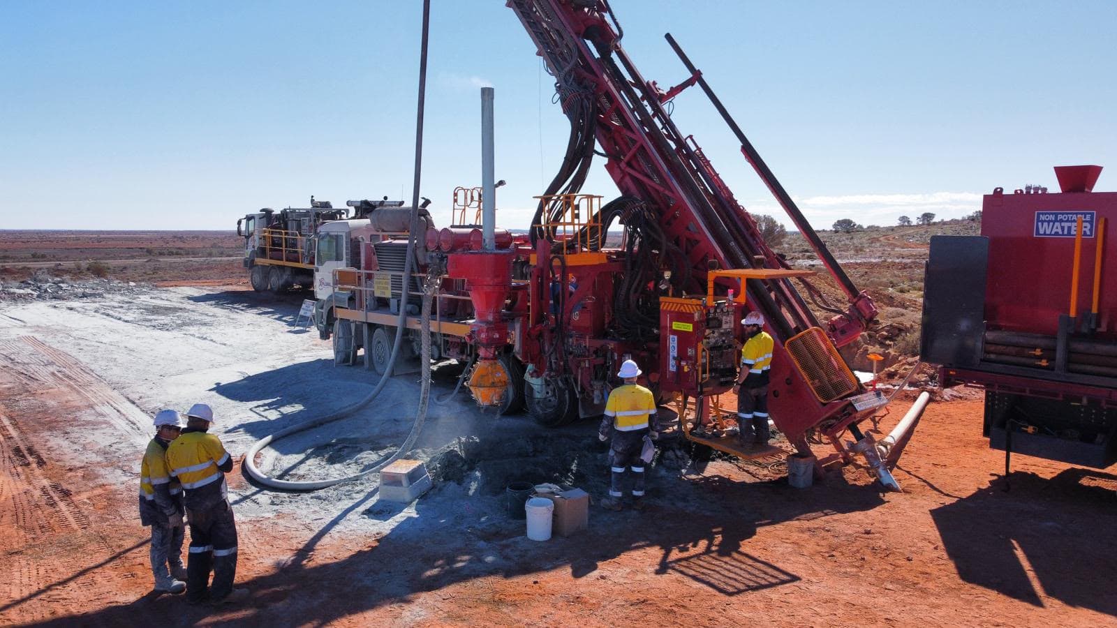 Xplore Drilling crew beside an operating RC rig in the Western Australian outback