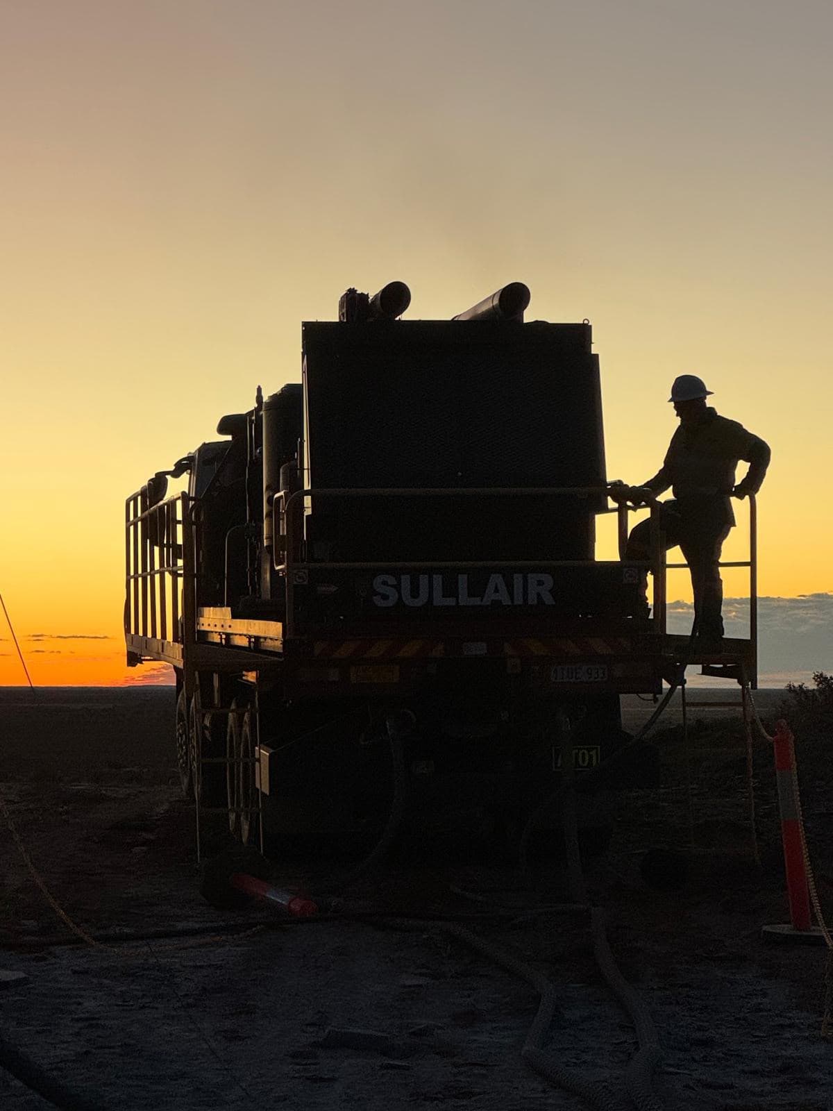 Crew member silhouetted against the outback sunset at end of shift
